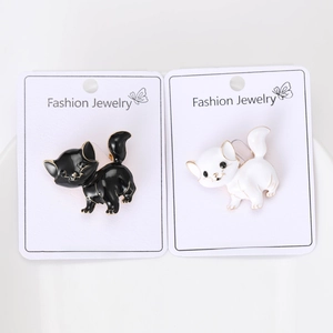 Detail of vintage black and white enamel cat brooches for suits and clothing in a 2-piece set