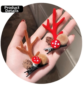 Close-up of Christmas hair clips with plush antlers, pine cones and mushroom decor