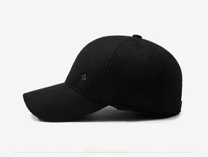 Side view of black winter baseball cap with side ear flaps and diamond metal logo