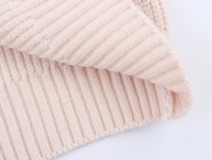 Detailed macro view of pink knit ribbing texture showing soft elastic fabric quality