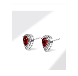 Detail of s925 silver pear shape stud earring with red zircon and halo setting
