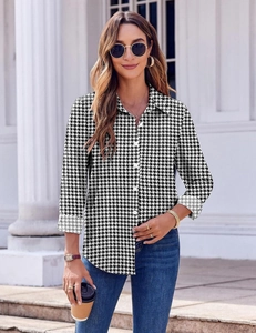Detail shot of a women's long-sleeve houndstooth shirt in classic black and white style