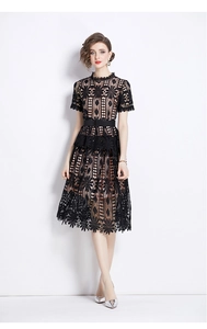 Close-up of intricate hollow out floral lace texture and waist belt on a black dress