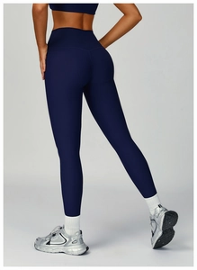 Detail view of high waist ribbed yoga leggings with push-up effect in deep blue color