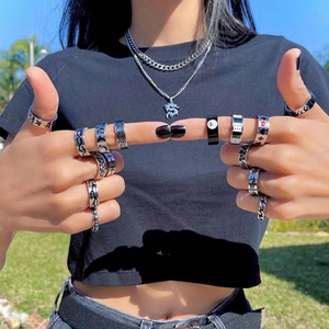 Gothic titanium steel ring set with flame and cross designs worn in natural outdoor light