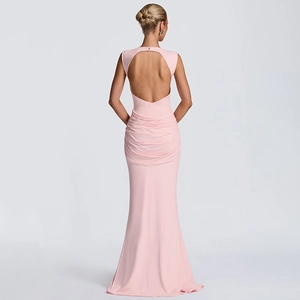 Detail of a pink backless long dress with cutout design and ruching on the lower back