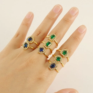 Close-up of gold 18K plated rings featuring heart and oval shaped zircon gemstones