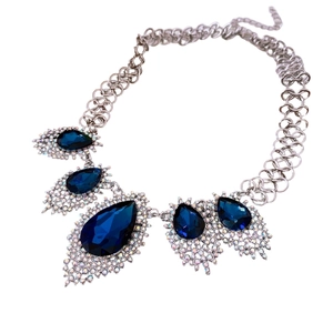 French style silver necklace featuring deep blue teardrop gems and sparkling accents