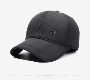 Detail view of quilted baseball cap with warm diamond stitching and metal side badge