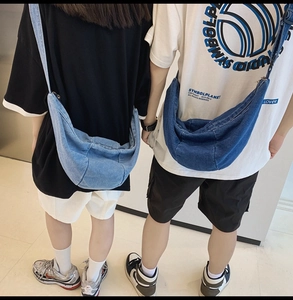 Dual view of blue denim crescent crossbody bags showing fit and drape on models