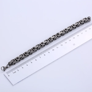 Detailed view of a 9mm black Byzantine chain bracelet measuring 20cm on a metric ruler