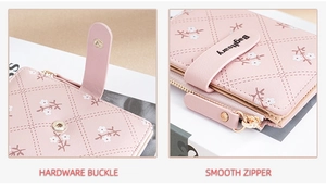 Detail of pink wallet with floral pattern, hardware buckle, and smooth zipper closure
