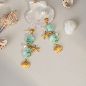 Golden starfish and shell drop earrings with sea blue gemstones and pearls on sand