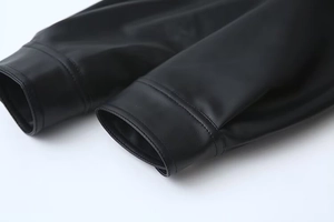 Close-up of the black PU leather jacket cuff showing detailed stitching and premium texture