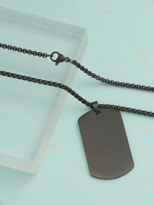 Macro view of black stainless steel dog tag pendant with matching box chain necklace