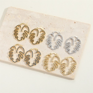 Minimalist monstera leaf earrings set with zircon stones in gold and silver finishes