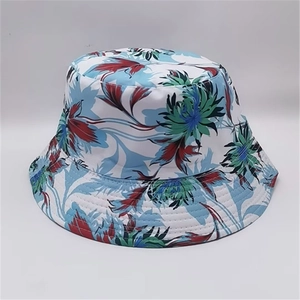 Detailed close-up of summer sun hat with colorful tropical leaf pattern on white cotton