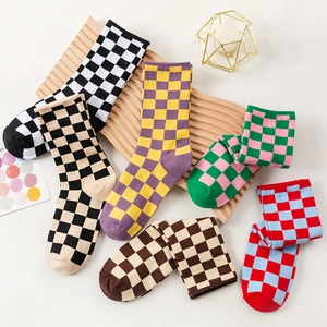 Classic checkered crew socks in six assorted colors displayed on a wooden tray