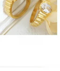 Detailed macro view of retro gold titanium steel ring with ribbed texture and oval zircon
