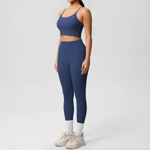 Side view of model wearing a navy blue high-waisted yoga set with sports bra and leggings