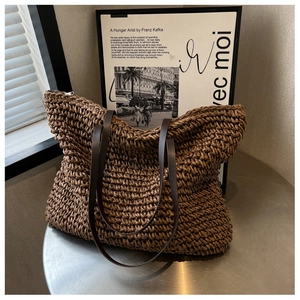 Macro view of woven tote bag texture with premium dark brown leather shoulder straps