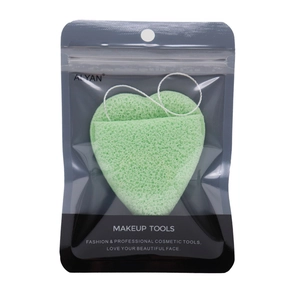 Macro detail of heart-shaped green face sponge in professional hanging pouch packaging