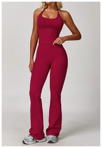 Front view of deep red halter yoga set with high waisted flared pants on female model