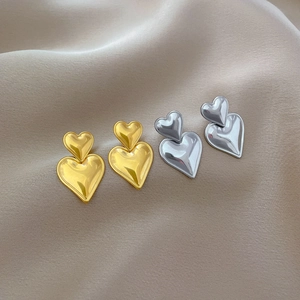 Polished titanium steel double heart stud earrings in gold and silver finishes