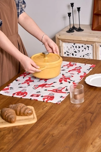 Close-up of Santa Claus print napkins and red table runner for festive Christmas decor