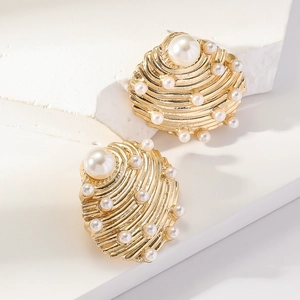Golden sea shell drop earrings with white pearls for a coastal beach vacation style