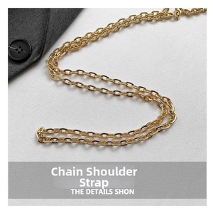 Detailed close-up of the elegant gold metal chain strap featuring oval link construction