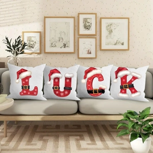 Set of 4 Christmas pillow covers with snowflakes and belt motifs on a beige sofa