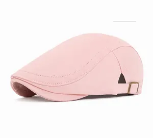Close-up of pink cotton flat cap featuring contrast stitching and side metal buckle detail