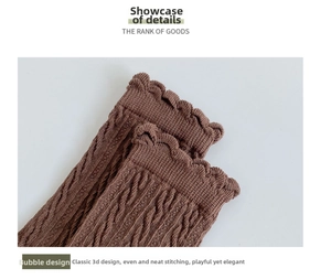 Close-up of dark brown knit socks with vintage cable pattern and frilly bubble edge