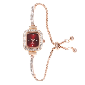 Detail of rose gold square quartz watch with red dial and crystal-encrusted sliding band