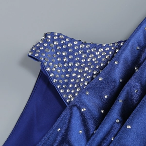 Detailed view of silver rhinestones and glossy satin texture on star blue evening dress