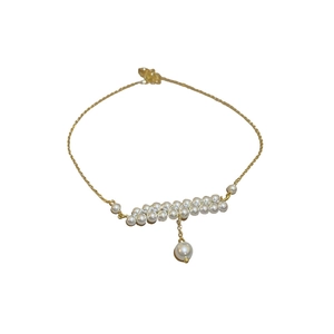 French vintage double-layered pearl necklace with golden chain and pendant on white background