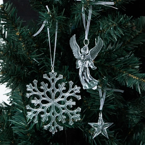 Clear acrylic Christmas ornaments featuring angels and stars on a green pine tree
