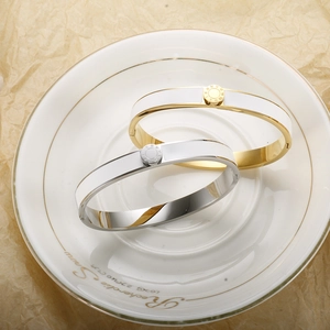 Detailed shot of Roman numeral engraved bangles in gold and silver with enamel inlay