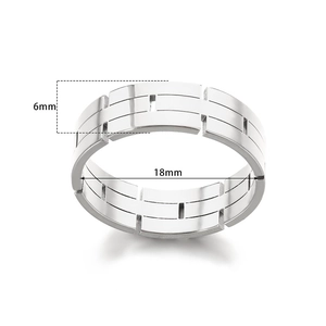 Detail view of 6mm silver geometric ring showing parallel lines and vertical groove cutouts