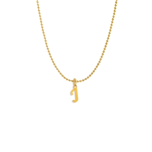 Detail shot of a golden bead chain necklace featuring a polished letter T alphabet pendant