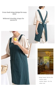 Detail of dark green cotton linen apron featuring X-back straps and wide shoulder bands