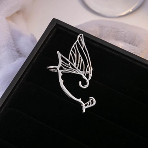 Silver butterfly wing cuff earring for women with minimalist fairy wing design on black velvet