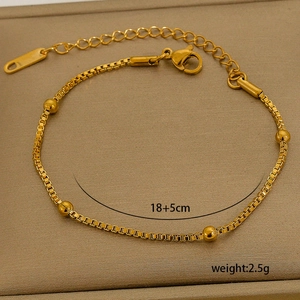 Detail of 18K gold plated box chain bracelet with beads and adjustable lobster clasp