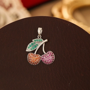 Macro shot of cherry pendant featuring red and purple crystals on silver base