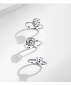Detailed view of silver stackable rings with oval, round, and princess cut crystals