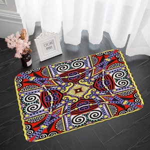 Detail of colorful geometric kaleidoscope rug with yellow scalloped edges on wood floor