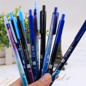 Close-up of hand holding colorful constellation themed mechanical pencils with Chinese text