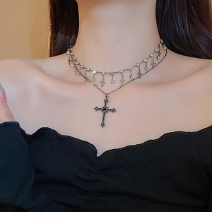 Detail view of double-layer vintage necklace with crystal cross pendants on model