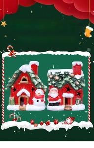 Detail of two red ceramic Christmas house figurines with Santa, snowman and LED star cutouts